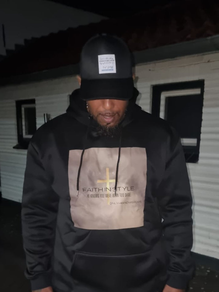 Modebewuste man in de OnlyHeKnows25® Limited Edition Zwarte Hoodie ‘Jesus Is King’, gemaakt van premium katoen/polyester, met een krachtige boodschap en comfortabele pasvorm.